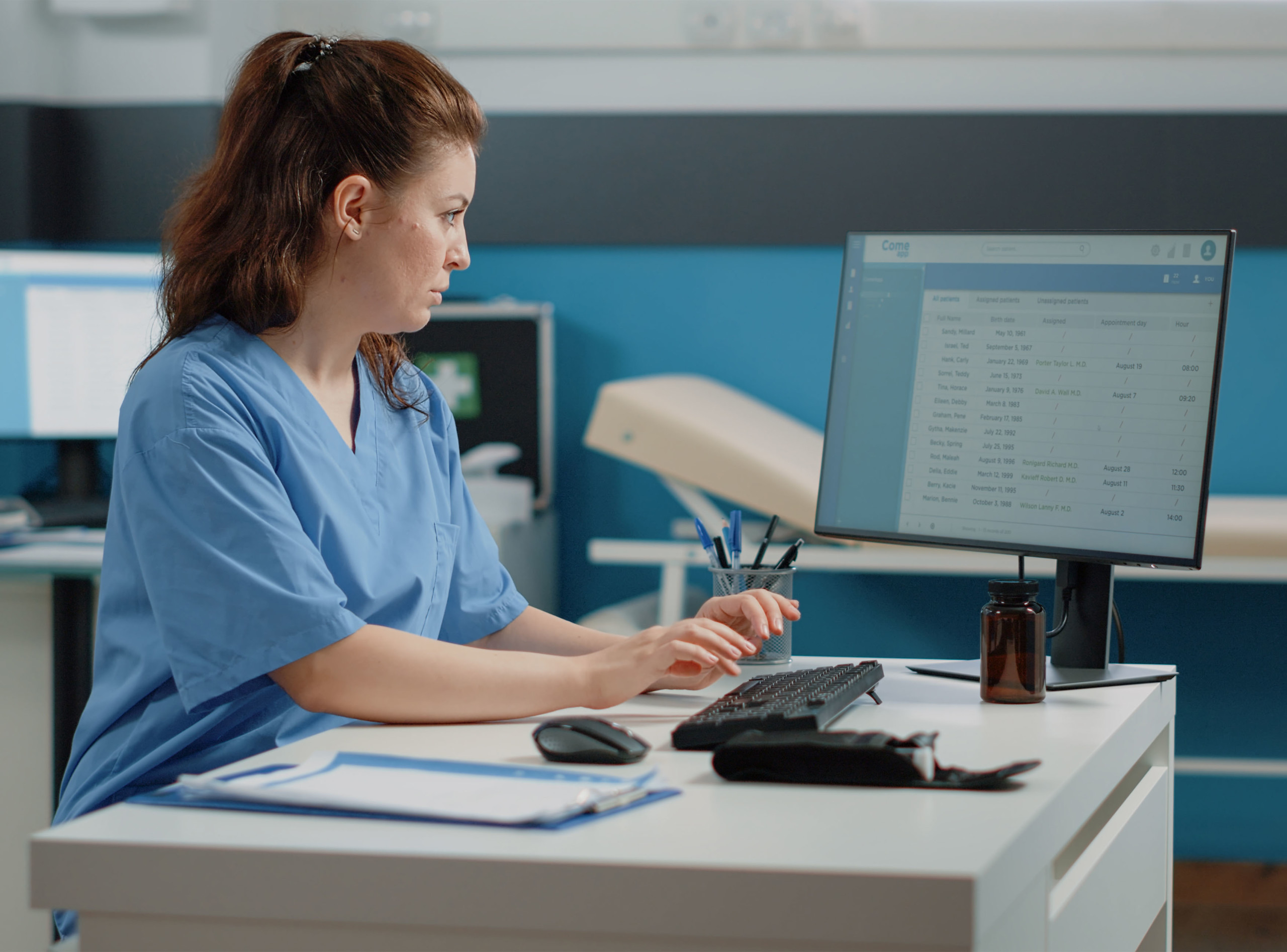 Nurse looking patient record on a computer