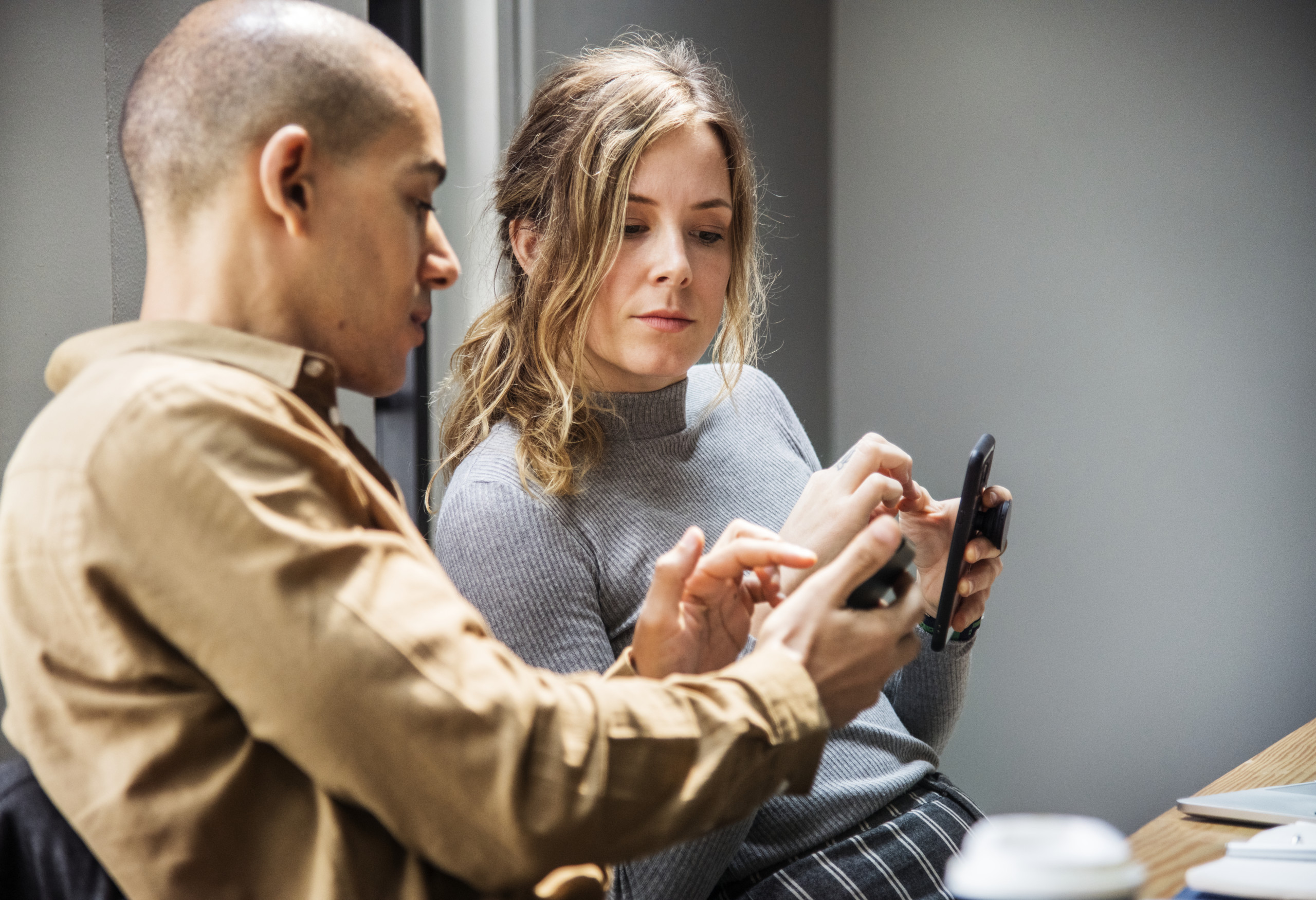 Man showing something on a smartphone to a woman