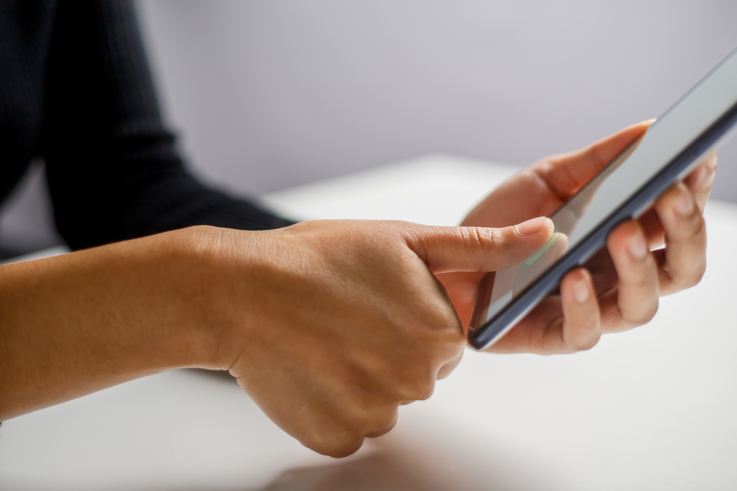 Man using smarphone with fingerprint id
