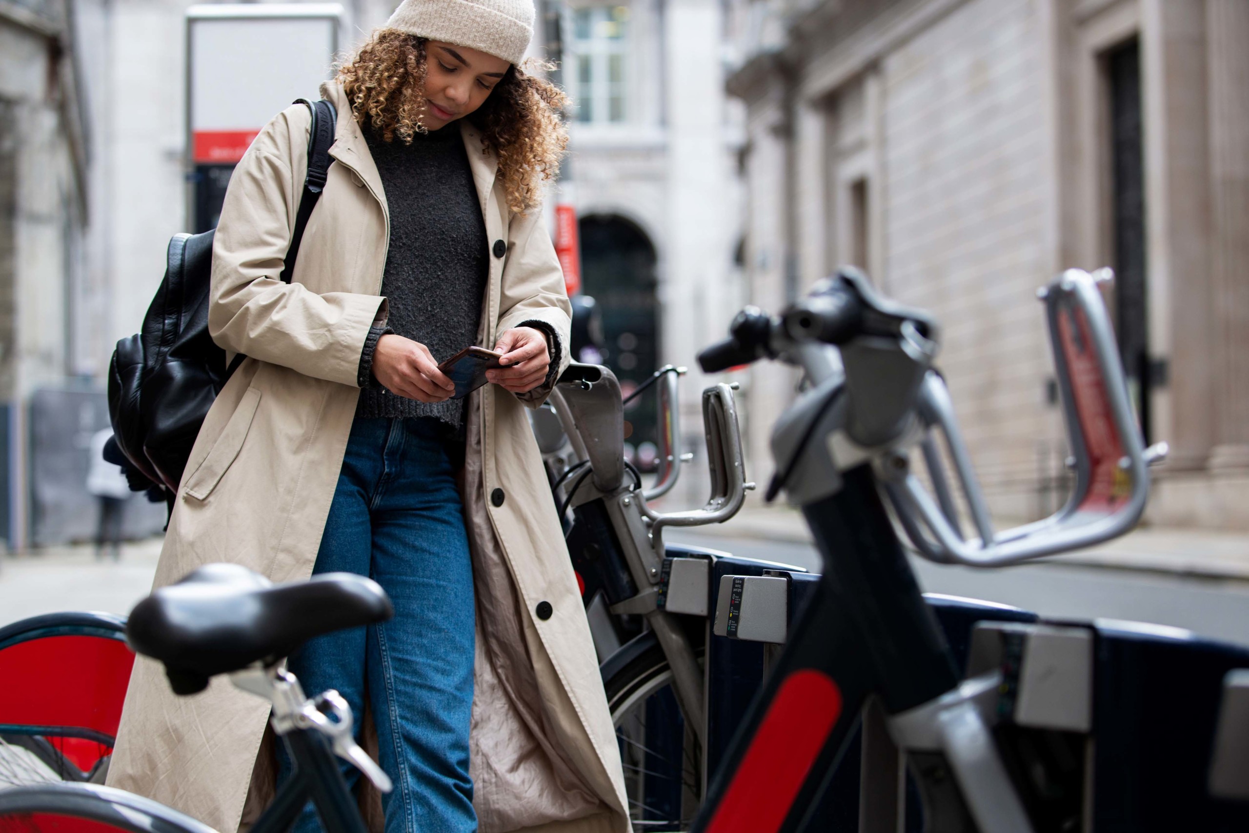 Black woman using phone in the city