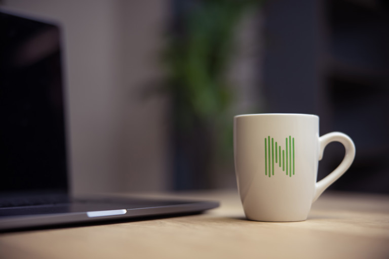 Nortal mug next to computer