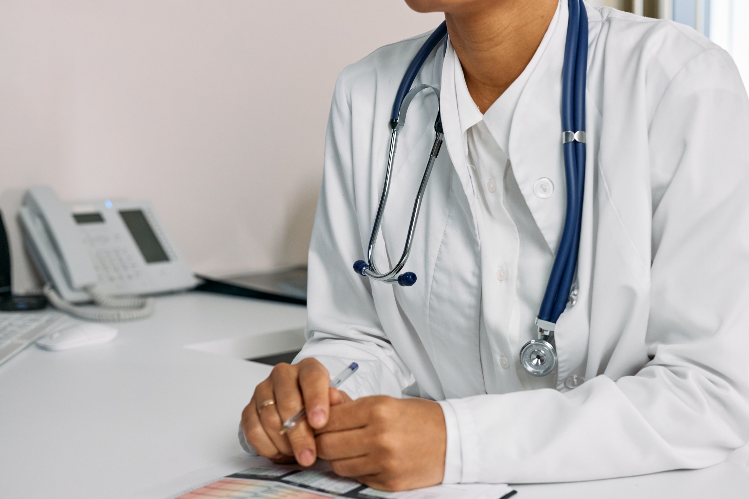 Female medical professional sitting at desk