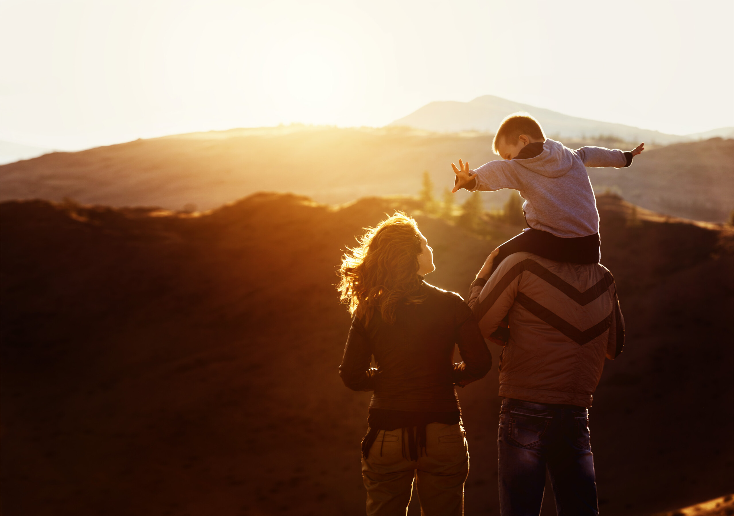Young family with their chils enjoying the sunset