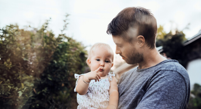 man holding a little daughter