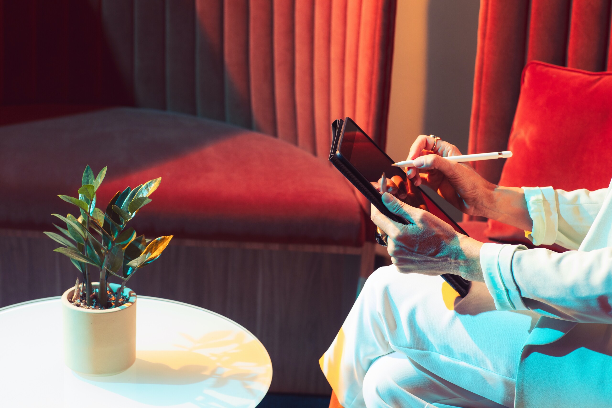 Woman using tablet in a red room