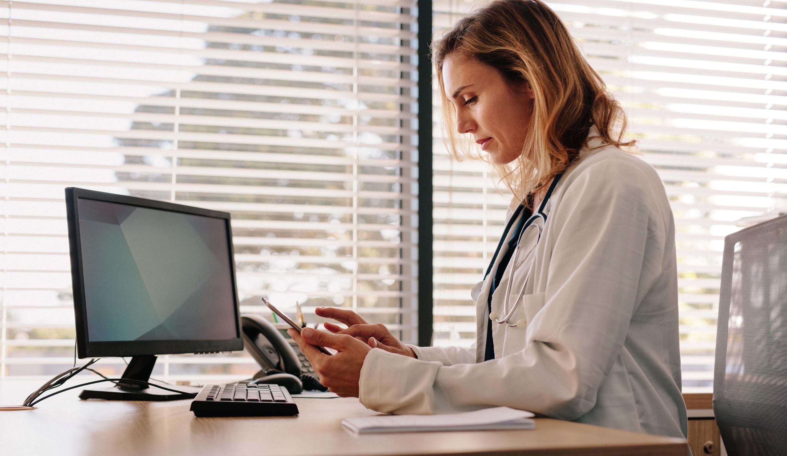 Doctor sitting behind a computer