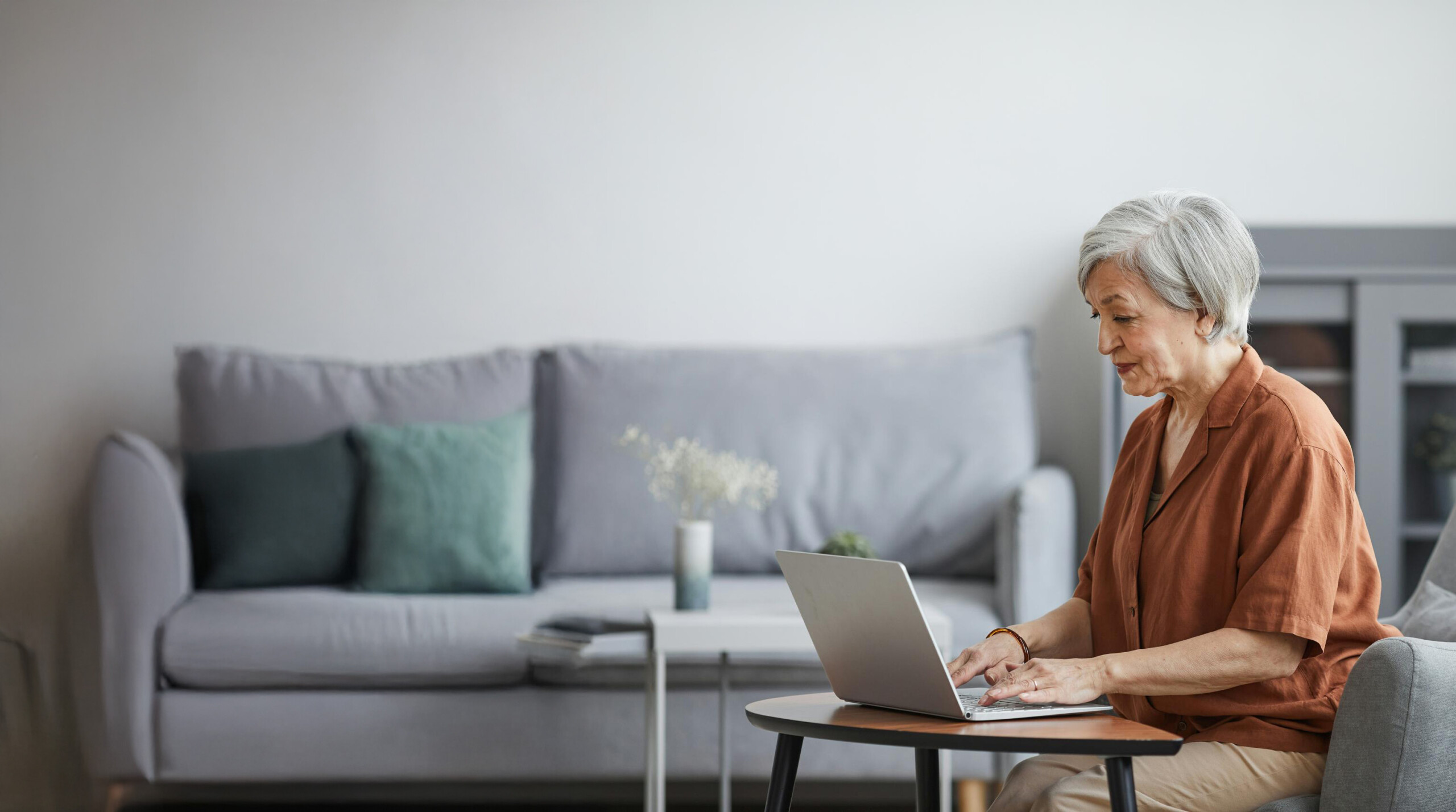 Older woman using laptop at home